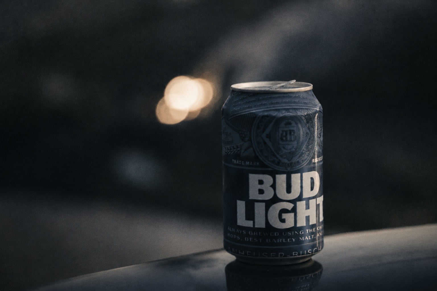 A can of Bud Light against a dark, softly lit background